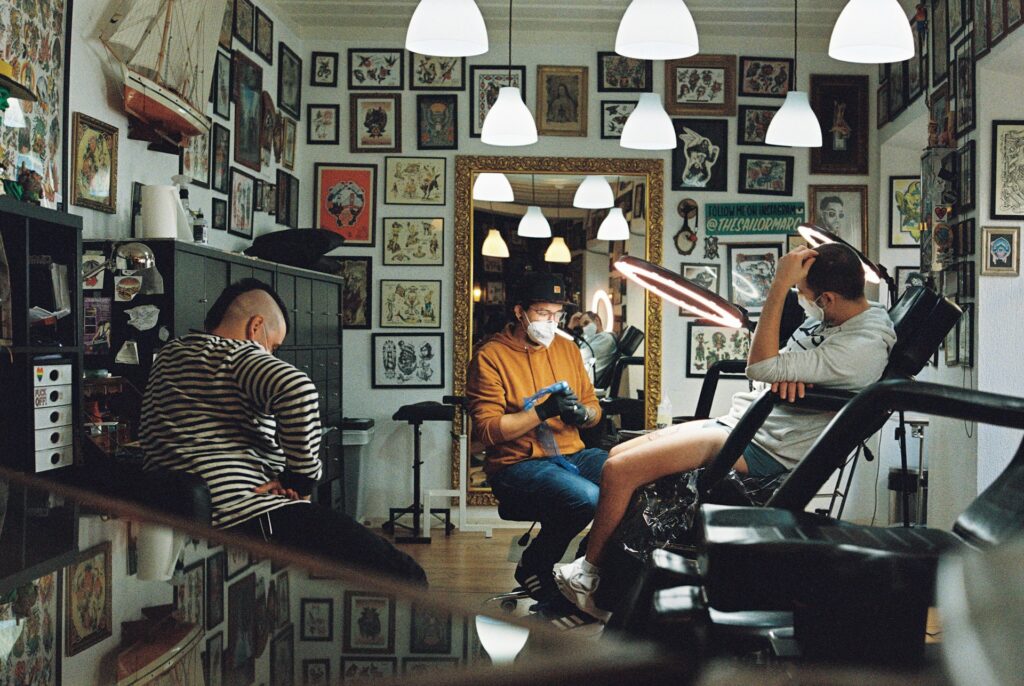 People in a tattoo studio getting ink. 